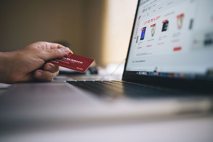 A closeup of a credit card and computer screen